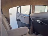 a view of the inside of a car from the driver ' s seat