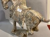 a statue of a horse that is sitting on a table