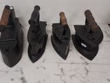 four pairs of black leather shoes are lined up on a counter