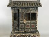 an old black and white wooden cabinet with a door and a window