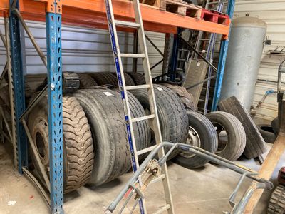 a lot of tires and a ladder in a garage