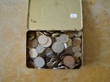 une boîte remplie de pièces de monnaie posée sur une table