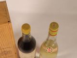 two bottles of wine sitting next to a wooden box