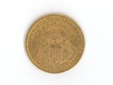 a close up of a gold coin on a white surface