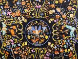 a close up of a black and orange floral design on a black background