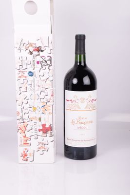 a bottle of wine sitting next to a wine box