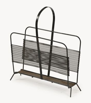 the magazine rack is holding a bunch of magazines on it