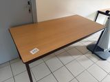 a wooden table with a sign on it in a room