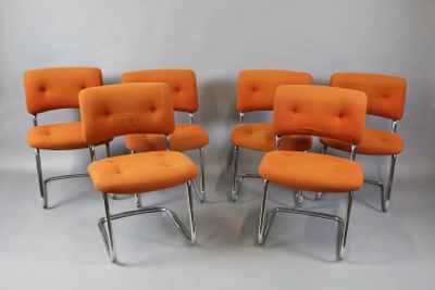 six orange chairs with chrome legs and a cushion on them
