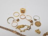 a lot of gold rings and bracelets on the table