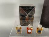 three bottles of perfume sitting on a clear table