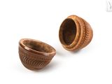 two small wooden bowls sitting next to each other on a white surface