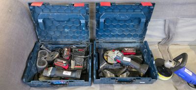 two blue tool boxes with tools in them on the floor