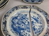 several plates with blue and white designs are stacked on top of each other