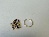 two gold rings with blue stones on them and a gold ring with a blue stone