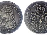 a silver coin with a crown on top of it
