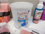 bottles of epilwax are sitting on a counter next to other items