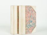 two books are stacked on top of each other on a white surface