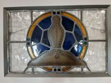 a stained glass window with a bird on it