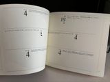 an open book with numbers on it on a table