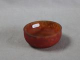 a small bowl with a tag on it on a table