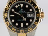 rolex watch with black dial and two tone gold bezel