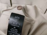 a close up of a white pants with a black label on it