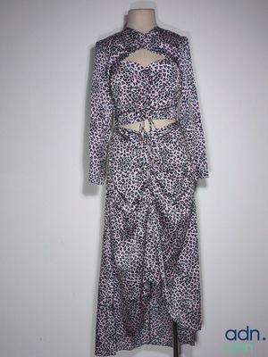 the dress is purple and white with black spots on it