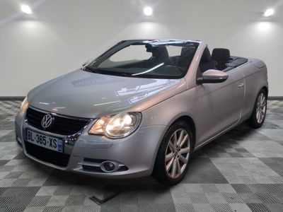 a picture of a silver convertible car parked in a garage