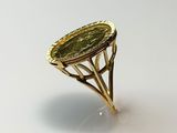 a close up of a gold ring with a green stone in it