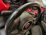 a steering wheel and dashboard of a small car