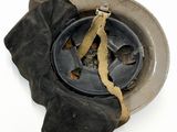 a dirty helmet with a piece of cloth on it