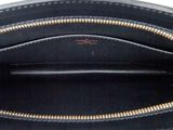 the inside of a black purse with gold zippers on it