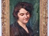 portrait of a woman in a black dress by a gold frame