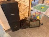 two speakers and a television sitting on the floor