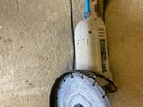 a small circular grinder sitting on the floor next to a small circular grinder