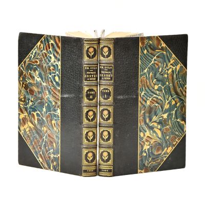 an old book with gold and black designs on it