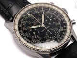 a close up of a watch on a white surface