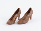 une paire de chaussures à talons hauts marron sur fond blanc