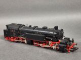 a black and red train engine on a gray surface