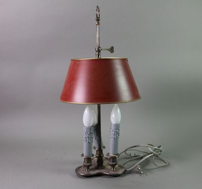 a lamp that has a red shade on top of it
