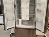 an open refrigerator in the middle of a warehouse