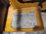 a close up of a yellow machine with a metal plate on it ' s side