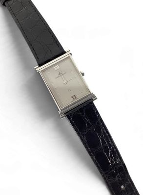 an image of a watch with a black strap on a white surface