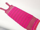 purple and pink dress on a white table with a white background