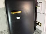 a black refrigerator sitting on a counter in a kitchen
