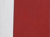 a red book sitting on a table next to a black and white wall