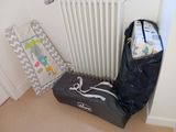 a black bag sitting next to a white radiator in a room