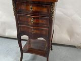 a small wooden table with a drawer on top of it
