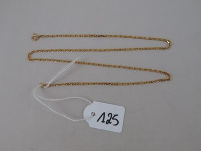 two gold chains with a price tag on a white background